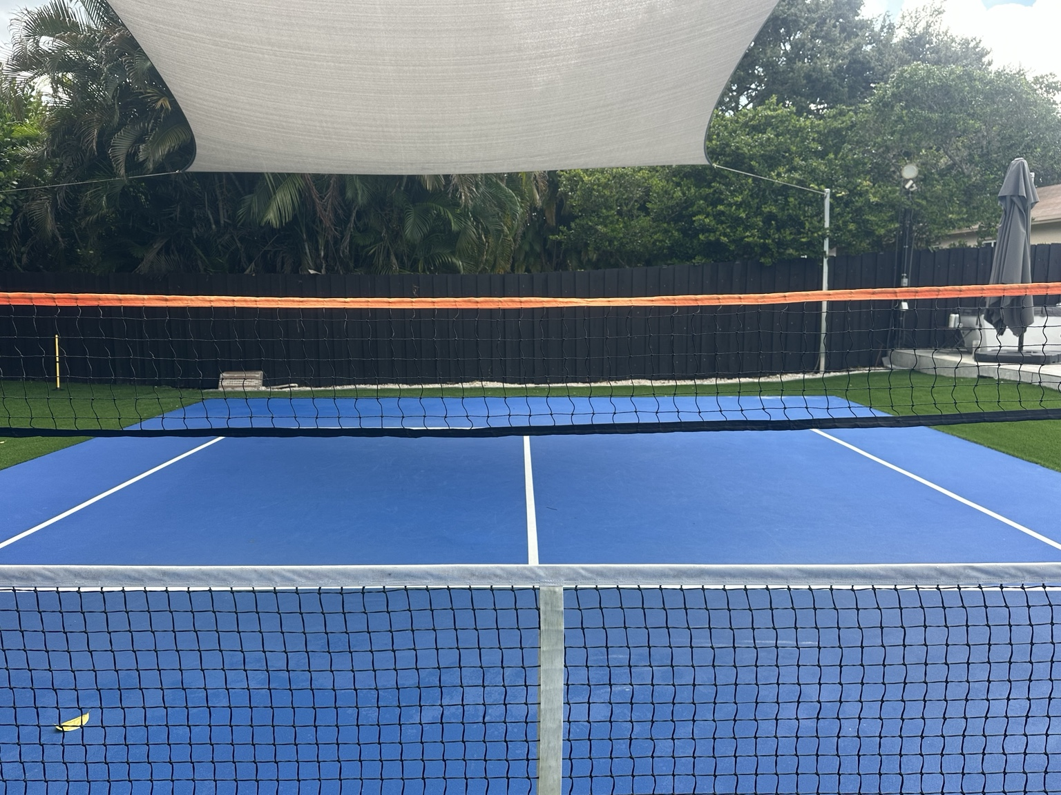 PRONET training net installed directly above a standard pickleball net, forming the Gap